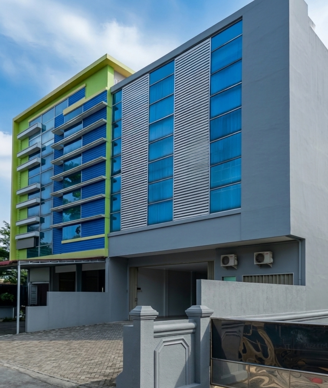 PT Delta Media Metatama branch office building — modern architecture with blue glass facade in Medan, Indonesia